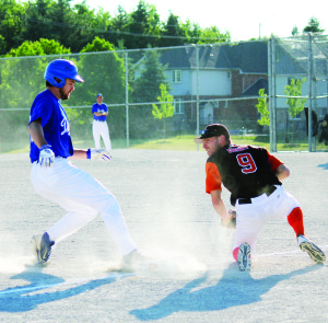 A ball gets past Orangeville's Nathan Drury as Bolton's Andrew English pulls into third base at Princess of Wales Park Friday. The Giants won the meeting 7-2. Photo by Jake Courtepatte