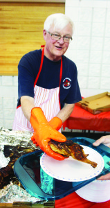 There was a large crowd out last Thursday night at the Brampton Fairgrounds for the annual Chicken Barbecue hosted by Mayfield United Church. Rob Thompson was one of those in charge of serving up the chicken. 