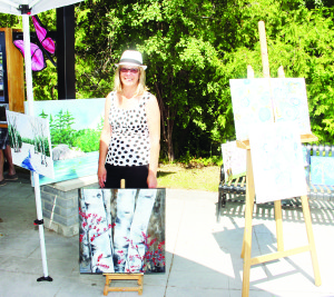BIA holds first summer event The Bolton Business Improvement Area (BIA) held the first in a series of summer promotion events Saturday. Palgrave artist Lorraine Savio was showing a collection of her acrylic, water colour and oil creations as part of Art in the Park. Photos by Bill Rea