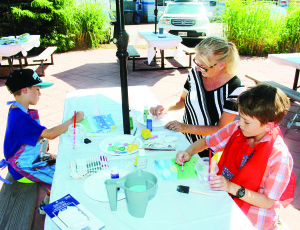 Local youngsters got the chance to try their creative hands are Art in the Park. Melanie Partland of Bolton was assisting Aidan and Noah Gregory of Palgrave.