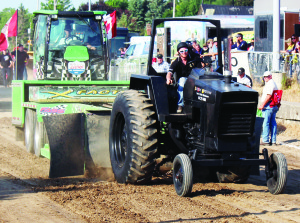 The Albion-Bolton Fairgrounds was definitely not the place for people with tender ears Friday night, but was the place for those who like seeing powerful machines put through their paces. The occasion was the 38th annual Bolton Truck and Tractor Pull, put on by the Albion and Bolton Agricultural Society. Caledon resident Robert Kolb, president of the Society, was pulling the weight down the track in the 8,000-poind modified farm tractor class in a machine called Extreme Impression. The pull was 263.5 feet. 