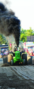 Charles Rivett of Beeton won the 10,500 pound modified farm tractor competition with the John Deere machine with a pull of 311.11 feet.