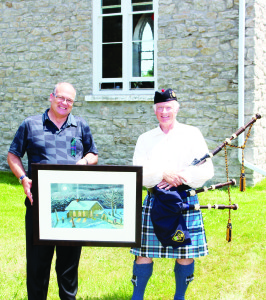 The festivities included the auctioning of this painting of the church. Mayor Allan Thompson is seen here with the artist, Joe Thompson.