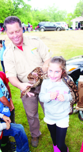 There was a large and enthused crowd out Friday for the 20th Caledon Canada Day Celebration at Albion Hills Conservation Area. The interesting attractions included an assortment of animals from Reptilia. Blair Watson was helping Gemma Palozzi, 7, from Newmarket with this Dumeril's boa named Doom. Photos by Bill Rea