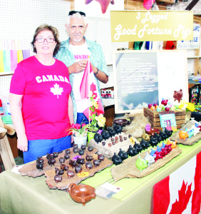 Margaret Hushion of Port Credit and Alex Alejandro of Chile were selling a selection of three-legged, good fortune pigs.