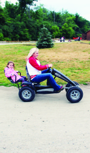 Getting around the pedal car track is easy if Mom's doping all the work. Councillor Jennifer Innis was providing the muscle power for her daughter Lyra, 3.