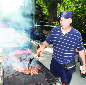 There was plenty of food available, as the Cheltenham Firefighters were busy barbecuing. Here, retired firefighter George Newhouse is seen hard at work at the grill.