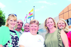 Peel Pride Chairperson Sonya Shorter stood before the raised Rainbow Flag outside Town Hall Tuesday, accompanied by Dufferin-Caledon MPP Sylvia Jones and Councillors Nick deBoer, Rob Mezzapelli, Jennifer Innis and Barb Shaughnessy. Photo by Bill Rea