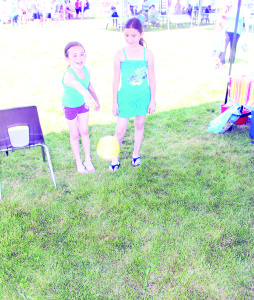 Olivia Soars, 8, of Inglewood and her sister Ava, 10, were trying their skill with some of the games set up at Inglewood Day.