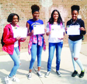 Kelly Mgbatogu, Keisha Campbell, Gurveen Gill, Devonie Ramson, students at Mayfield Secondary School, with their ChangeTheWorld certificates, after participating in a food drive they organized for the Caledon Exchange.