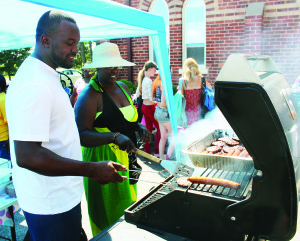 BACK TO SCHOOL BBQ School is soon to resume, and members of North Peel Community Church in Sandhill marked the occasion Saturday by hosting a Back to School Barbecue. Sheldon Jones and Stephanie Gordon were busy with the cooking chores. Photo by Bill Rea