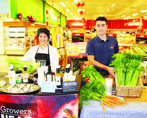 PROMOTING LOCAL PRODUCE Christina Atchione recently joined Steven Kamenar of Hillside Gardens in the Holland Marsh at the Zehrs outlet in Bolton. It was part of a promotion of local produce at Loblaws and Zehrs stores, as both stores get about half of the produce locally during peak growing seasons. Photo by Bill Rea