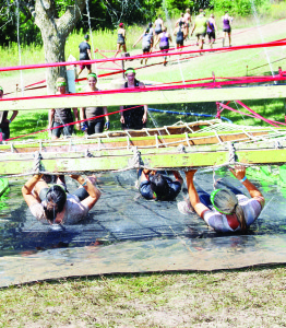 Participants had to drag themselves through some of the obstacles, like this one.