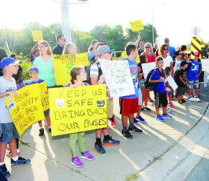 Parents and students from St. Nicholas Catholic Elementary School in Bolton were at the intersection of Coleraine Drive and Harvest Moon Drive Tuesday morning, protesting the reduction in busing of students to the school. Photo by Bill Rea