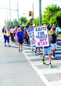 A crossing guard was assisting marchers get across Harvest Moon Drive during Tuesday morning's protest.