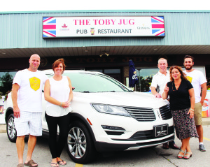 FUNDRAISER FOR BETHELL HOSPICE Fines Ford Lincoln, The Toby Jug and Caledon Hills Brewery combined their efforts Saturday to host a fundraising event for Bethell Hospice. There was also the opportunity to buy tickets for the draw with this 2016 Lincoln MKC SUV as the grand prize. The draw will take place later this month at Bolton Fall Fair. Stephan Riedelsheiner and his son Sebastian of Caledon Hills were flanking Carolyn Banks of The Toby Jug and Jo-Anna Gould of Bethell Hospice. Photo by Bill Rea