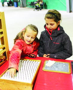 There were plenty of old-fashion games at the display table set up by the people at Old Britannia Schoolhouse. Adelaide and Clea MacDonald from Oakville were checking them out.