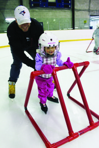 Shannon Mahon of Inglewood was helping his daughter Sophia, 2, try out skates for the first time Sunday in Inglewood.