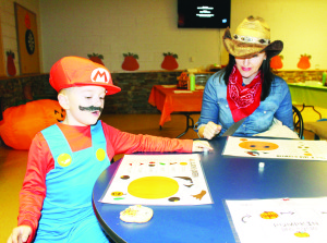 Kristina Weiss of Bolton was playing Roll a Jack-o-Lantern with her son Austin, 6.