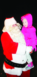 FESTIVITIES IN ALTON The community gathered in Alton Village Square Saturday evening for a ceremonial Christmas tree lighting. Those on hand included Santa Clause, who met many of his friends, including two-year-old Olivia Hall. Photo by Bill Rea