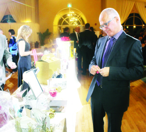 The evening included many interesting items available in the silent auction. CCS CEO Monty Laskin was looking over some of the items. Photos by Bill Rea
