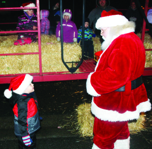 HAYRIDES IN CHELTENHAM Members of the Cheltenham community were out last Friday night celebrating the holidays with hayrides around the hamlet. Santa Claus was on hand with goodies and to meet some of his friends. Parker Huyvenhoven, 2, of Huttonville took the opportunity to tell Santa what he wants for Christmas. Photo by Bill Rea