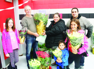 There were plenty of poinsettias waiting to be picked up. Ella Millar-Maggi and Dan Kolb were assisting as Angela Bellantoni, Justin Parete, Damien Bellantoni-Parete, 3, and Mia Bellantoni-Salvacci, 10, collected theirs. Photos by Bill Rea