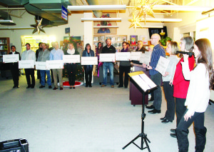 While Bolton vocalist Carly Cianflocca performed a song, participants in Tuesday's vigil held placards bearing the names of the victims of the Montreal Massacre.