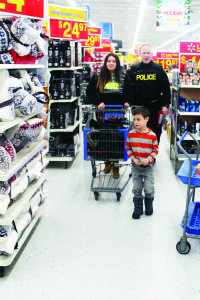 Sergeant Paul Baton was accompanied through the store by Sierra Jones, 15, and Jayden Tricoca, 6.