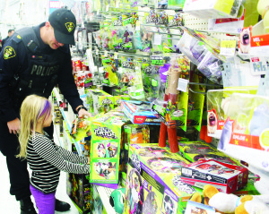 Police officers pushed the carts in Shop With a Cop Saturday saw the fifth annual Shop With a Cop event at the Walmart outlet at Bramalea and Mayfield Roads. Many officers from Caledon OPP were on hand with gift cards for young people to do some holiday shopping, including something for themselves. After the shopping was done, participants went for breakfast at Robert F. Hall Catholic Secondary School in Caledon East. Sergeant Jeff Barker was helping Alexus Gillard, 6, pick some items off the shelf.