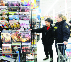 Constable Christina Sanghera and Koby Mininni, 12, were looking over some of the items on the shelf.