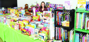 Kim D'Eri, manager of community animation with Caledon Community Services, was in the middle of a vast pile of contributions that were made to the Santa Fund this year. Photo by Bill Rea