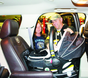 AUXILIARY OFFICERS HOST CAR SEAT CLINIC Caledon OPP's Auxiliary officers recently held the latest in their series of child car seat clinics at the Fire Hall in Bolton. Brenda Giadetti of Caledon was watching as Auxiliary Constable Danny Gallant adjusted the seat. The next clinic will be at the Bolton fire Hall at 28 Ann St. Jan. 31 from 6:30 to 9:30 p.m. For more Information and to book an appointment, call 905-584-2241. Photo by Bill Rea