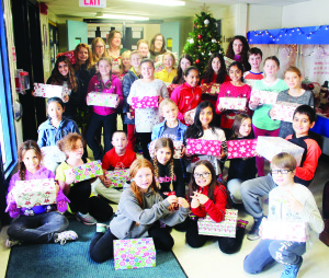 Teachers Angela Baldesarra and Jennifer Caruk are seen with some of the members of the Me to We club at Ellwood Memorial Public School involved in collecting items for Shoebox Project Canada. The shoeboxes were distributed to women shelters in Peel. They were able to fill 50 boxes and them some. Photo by Bill Rea