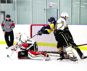 Caledon's Matt Magliozzi reaches for the puck in front of the Stayner Siskins' goal in the Golden Hawks' loss Sunday at Caledon East. Photo by Jake Courtepatte