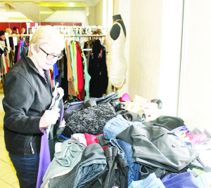SALE IN SUPPORT OF CHE'S PLACE There were lots of elegant clothing items available recently at Connect Church in Bolton. The Charity Boutique Sale, sponsored by the Optimist Club of Bolton, was in support of Che's Place Youth Centre. Carol Clifford-Smith of Bolton was going through some of the inventory. Photo by Bill Rea