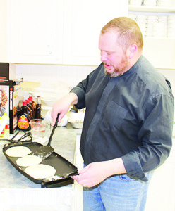 Rev. Greg Fiennes-Clinton was hard at work in the kitchen at St. James.