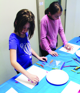 Last Thursday saw youngsters working on crayon dip art at the Inglewood branch Nicole Judge, 7, of Cheltenham and Abigail Defeo, 10, of Bolton were hard at work. Photos by Bill Rea