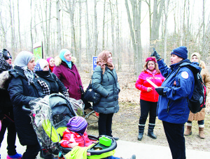 Ashoo Anand, Senior Coordinator for CVC's Multicultural Outreach Program, leads students through the park as they learn about maple syrup through the ages. Submitted photo