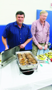 CHURCH HOLDS BEEF DINNER There were lots of hungry people out recently at Alloa Public School for a Beef Dinner, hosted by Home United Church. Bruce McClure and Bill Crawford were pitching in to serve the diners. Photo by Bill Rea