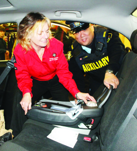 CHILD CAR SEAT CLINIC Auxiliary officers from Caledon OPP recently held the latest of their child car seat clinics at the Fire Hall in Bolton. Sheila McCaskill of St. John Ambulance was helping Auxiliary Constable Carey Yoshiki adjust this seat. The next clinic is scheduled for April 25 from 6:30 to 9:30 p.m. at the fire hall at 28 Ann St. in Bolton. It will be by-appointment only. Call 905-584-2241 for more information or to book an appointment. Police are reminding parents that the Ministry of Transportation reports research demonstrates that when a child car seat is installed correctly, it can lessen the likelihood of injury or death by 75 per cent. Photo by Bill Rea