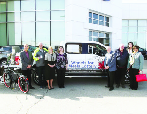 Members of Caledon Meals on Wheels, Caledon councillors, MPP Sylvia Jones and Bob Fines pose next to the grand prize in the new lottery — a Ford F-150 pickup truck.