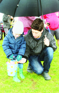 The rain was no problem if there was an umbrella handy. Loretto Veneziale, 3, was able to concentrate on collecting his eggs while his father Steve helped keep him dry.